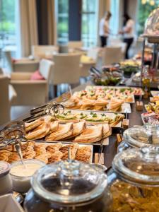 a buffet with many different types of food on a table at Hotel Olympia in Kopřivnice