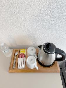 a tea kettle on a wooden tray with medicines at Suda Pansiyon in Bodrum City