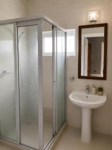 a bathroom with a shower and a sink at ARIEL BEACH VILLA* in Grand-Baie