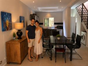 a man and a woman standing in a kitchen at ARIEL BEACH VILLA* in Grand-Baie +3 photos