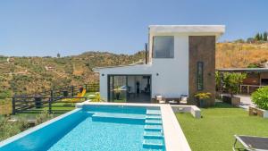 a villa with a swimming pool and a house at Villa Alborada Torrox by Ruralidays in Torrox