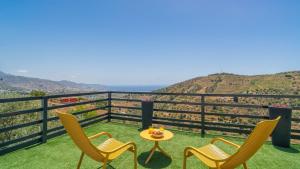 a table and chairs on a balcony with a view at Villa Alborada Torrox by Ruralidays in Torrox