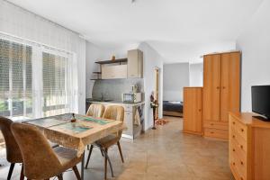 a kitchen and dining room with a table and a stove at Вила Далия - Несебър in Nesebar