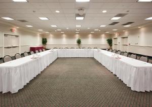 a row of tables in a room with white table cloths at Holiday Inn Redding by IHG in Redding