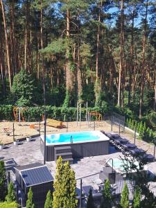 a swimming pool in a park with a playground at Domki Wakacyjne nad Jeziorem in Janowice