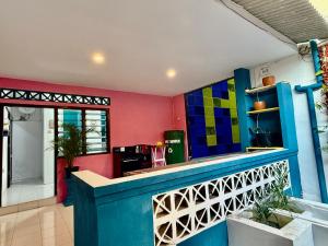 a kitchen with colorful cabinets and a counter at HHHH Hostel in Banyuwangi
