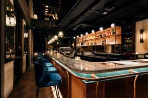 a bar with a row of seats in a restaurant at Ruby Lilou Hotel Marseille by IHG in Marseille