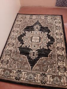 a rug on top of a wooden floor at Royal guest home in Mokowe