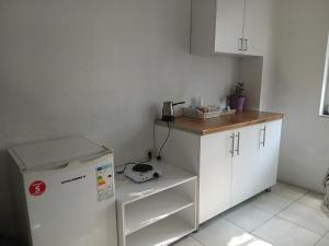 a kitchen with a white refrigerator and a counter at Sokak in Struga