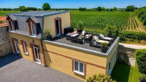 an aerial view of a house with a patio and a vineyard at Château de Montmireil in Canisy