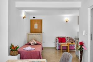 a room with a bed and a couch and a table at Вила Далия - Несебър in Nesebar