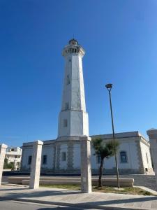 a lighthouse on top of a white building at Casa Francesca Appartamento a 200m dal mare in Torre Canne +3 photos