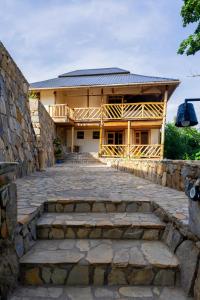 a building with a stone walkway in front of it at Riverside Gorilla Lodge - Bwindi in Kinkizi