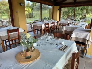 a restaurant with tables and chairs with white tablecloths at La Cà dOlga in La Morra +28 photos