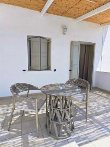 a table and two chairs on a patio at Alezina studios in Amorgos +44 photos