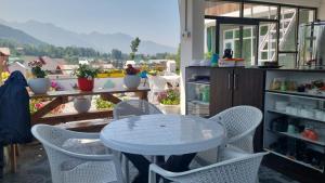 a white table and chairs on a balcony at FarahBakshResidency in Srinagar +22 photos