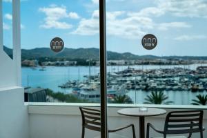 a table and chairs in front of a window with a view at The White Apartments in San Antonio