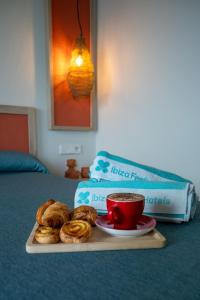 a tray of pastries and a cup of coffee on a bed at The White Apartments in San Antonio