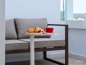 a table with a couch with a plate of food on it at The White Apartments in San Antonio