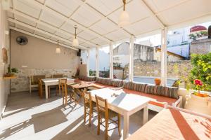 a restaurant with tables and chairs and windows at Rethymno Youth Hostel in Rethymno