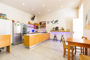 a large kitchen with a table and a refrigerator at Rethymno Youth Hostel in Rethymno
