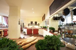 a kitchen with a bunch of vegetables on a table at Familotel Borchards Rookhus in Wesenberg