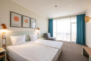 a hotel room with a large bed and a window at SOL by Meliá Nessebar Bay All Inclusive in Nesebar