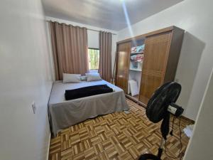 a bedroom with a bed and a chair in it at Casa da Nair in Sao Jorge