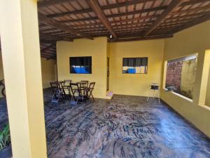 a room with chairs and tables in a room with a rug at Casa da Nair in Sao Jorge