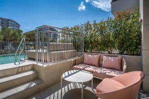 a patio with a couch and a table and chairs at Trendy Perge Resort & Suites in Aksu