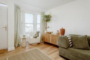 a living room with a couch and a chair at Quayside Apartments, Brixham in Brixham
