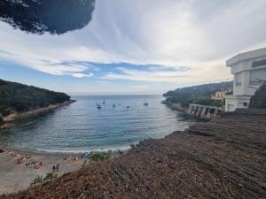 a beach with people and boats in the water at Echappée belle in Cros-de-Cagnes