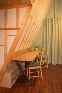 a wooden table and two chairs in a room at Lala Camp in Vama Buzăului +28 photos