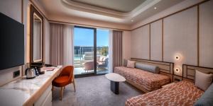 a hotel room with a bed and a desk at Trendy Perge Resort & Suites in Aksu +111 photos