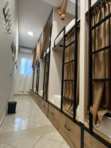 a dressing room with a row of mirrors at Queen-V Hostel in Vlorë