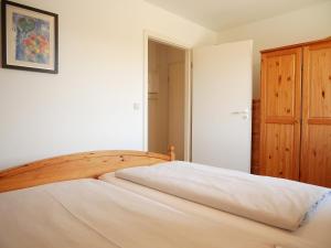 a bedroom with a bed with a wooden head board at Tschach in Kirchdorf
