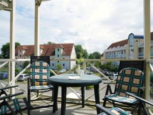 a table and chairs on a patio with a view of a building at Tschach in Kirchdorf