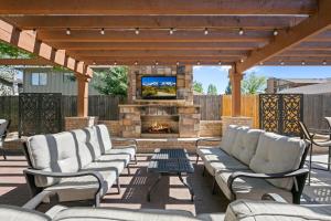 a patio with chairs and a fireplace with a tv at Flatirons Hideaway in Boulder CO in Boulder