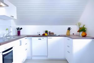 a white kitchen with white cabinets and a sink at Ferien- Monteurwohnung in Zülpich in Zülpich