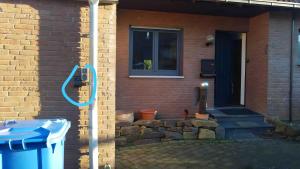 a house with a blue phone on the side of it at Ferien- Monteurwohnung in Zülpich in Zülpich