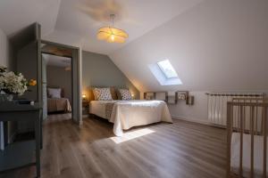 a bedroom with a bed and a skylight at L'ecrin de séraphie in Nojaret