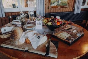 a table with bread and a plate of food on it at Gasthaus Fuchsacker in Degersheim +60 photos