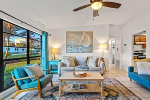 a living room with a couch and a table at Surf Drive - Ultimate Beach Getaway for Families in Cocoa Beach