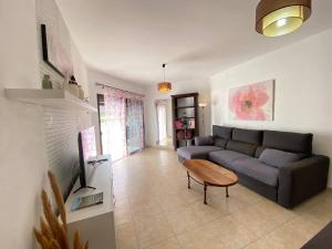 a living room with a couch and a table at Casa Candy. Piscina, Mar y Paz. in Tuineje