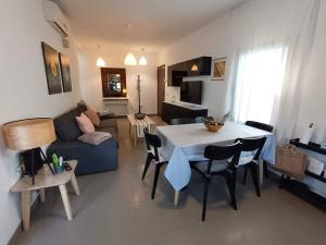 a living room with a table and a blue couch at Villa Majada Del Aceitun in Gran Tarajal