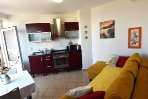 a living room with a couch and a kitchen at Villa NADA 1 in Podgora