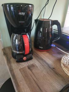 a black and red coffee maker on a wooden table at Leodi Place in Kipséli