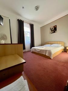 a bedroom with two beds and a red carpet at Sinziana Eforie Sud in Eforie Sud