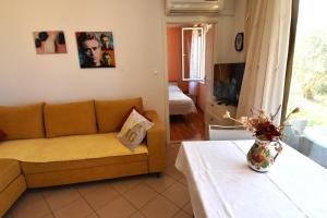 a living room with a couch and a table at Villa NADA 1 in Podgora