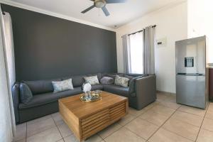 a living room with a couch and a coffee table at Trig Beacon in Manzini